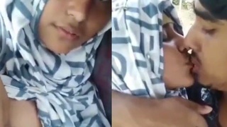 A Muslim girl enjoys her lover's oral pleasure on her breasts