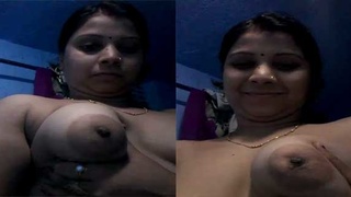 Bhabhi's smiling face as she flaunts her breasts and pussy