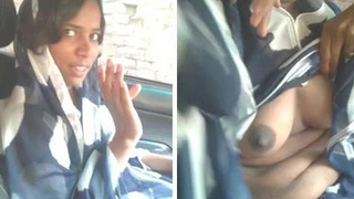 Indian babe with big boobs gives a blowjob in the backseat of a car