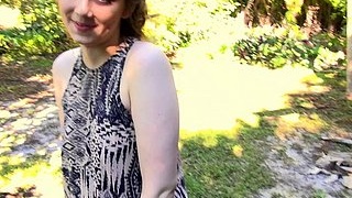 A stunning woman enjoys outdoor sex in a backyard, sucking and riding her partner