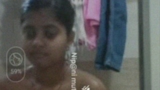 Indian woman enjoys a nude bath in the bathroom