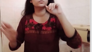 Desi bhabhi with long hair strips down for a bathroom selfie