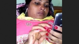 A naughty girl gets caught on camera while having phone sex