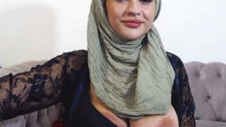 Watch as a Muslim woman with big breasts, Dalia, seductively reveals them in a steamy video